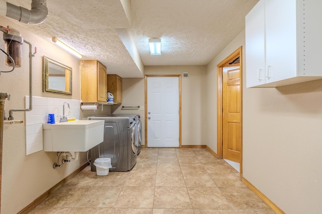 252 N Hightower Ave, Nixa, MO 65714 - laundry room with cabinet space, washing machine and dryer, and a textured ceiling