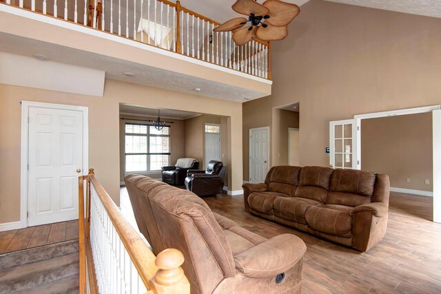 1108 N 18th Ave, Ozark, MO 65721 - living area featuring ceiling fan, wood finished floors, a chandelier, and a high ceiling