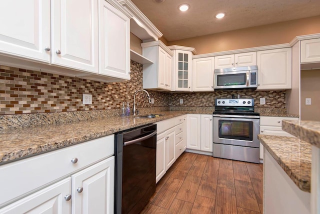 1108 N 18th Ave, Ozark, MO 65721 - kitchen featuring appliances with stainless steel finishes, white cabinetry, dark wood finished floors, recessed lighting, and glass insert cabinets