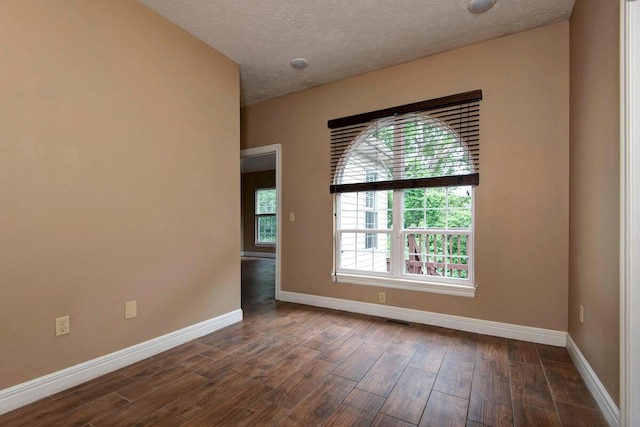 1108 N 18th Ave, Ozark, MO 65721 - empty room with dark wood-style flooring and a textured ceiling