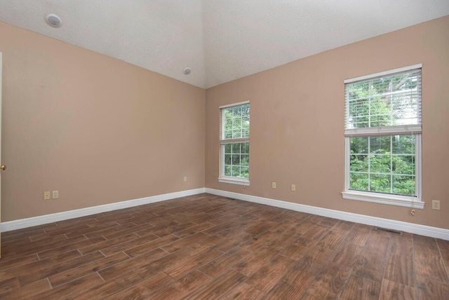 1108 N 18th Ave, Ozark, MO 65721 - unfurnished room with dark wood-style flooring, vaulted ceiling, and plenty of natural light