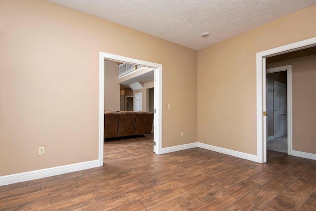 1108 N 18th Ave, Ozark, MO 65721 - spare room featuring wood finished floors and a textured ceiling