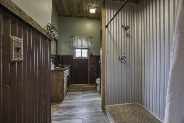 12132 W Farm Road 18, Walnut Grove, MO 65770 - bathroom featuring a wainscoted wall, wood finished floors, vanity, a shower, and wood walls