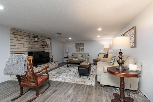 2225 N Plainview Ave, Springfield, MO 65803 - living area featuring wood finished floors, a stone fireplace, and recessed lighting