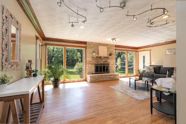 2225 N Plainview Ave, Springfield, MO 65803 - living room with ornamental molding, light wood-type flooring, and a stone fireplace