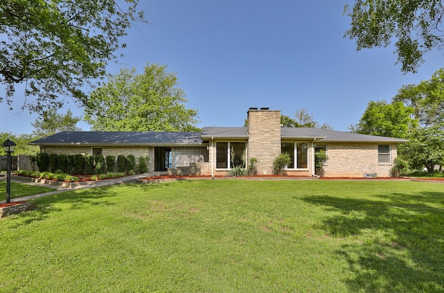 2225 N Plainview Ave, Springfield, MO 65803 - view of front facade with a chimney, a front lawn, and brick siding