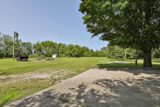 2225 N Plainview Ave, Springfield, MO 65803 - view of grassy yard with a shed and view of wooded area
