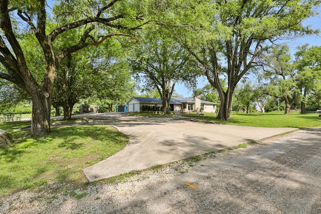 2225 N Plainview Ave, Springfield, MO 65803 - mid-century inspired home featuring a front yard, driveway, and a garage