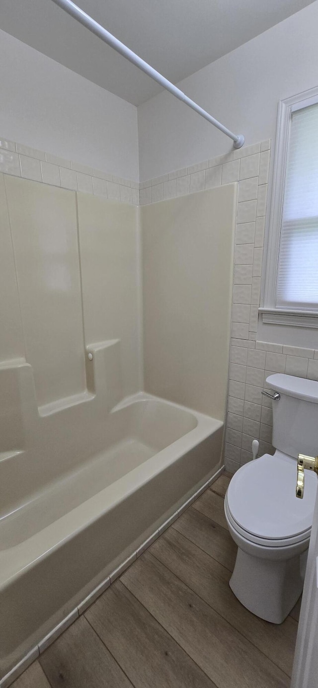 2782 W Swan St, Springfield, MO 65807 - full bathroom with shower / tub combination, wood finished floors, and tile walls