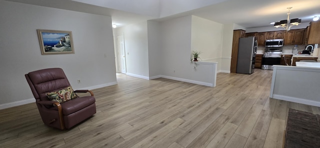 2782 W Swan St, Springfield, MO 65807 - sitting room with a chandelier and light wood-style flooring