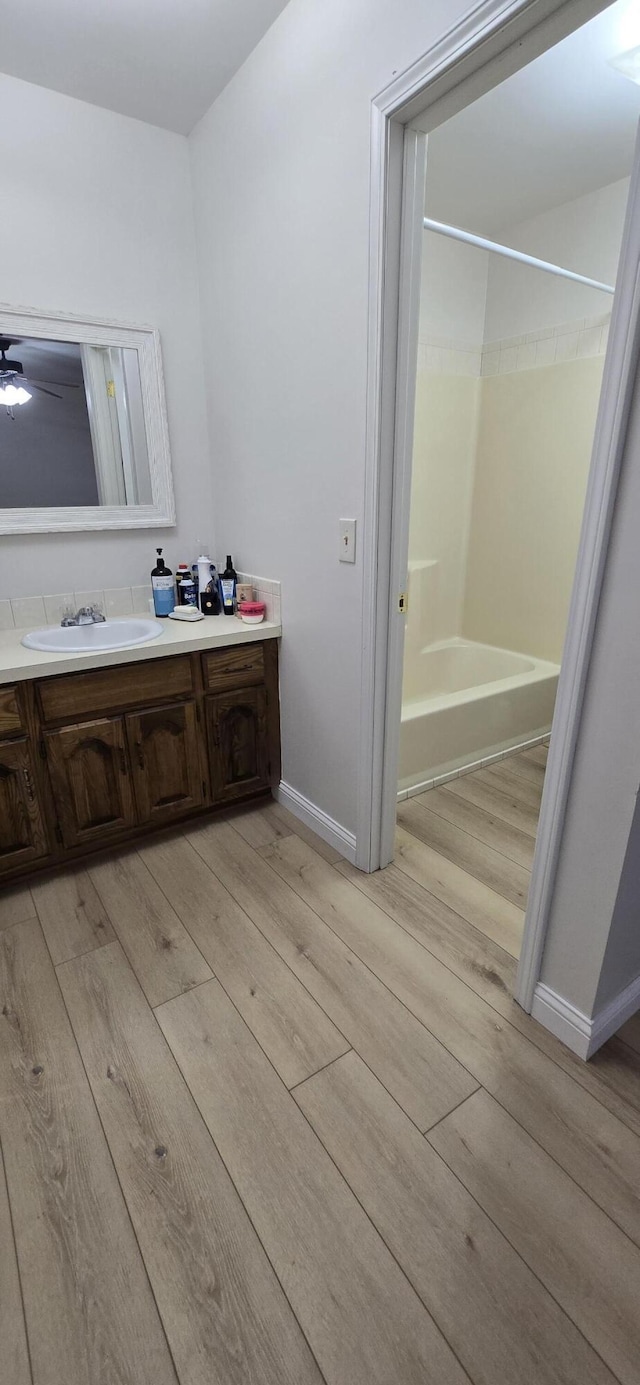 2782 W Swan St, Springfield, MO 65807 - bathroom featuring wood finished floors, vanity, bathtub / shower combination, and ceiling fan