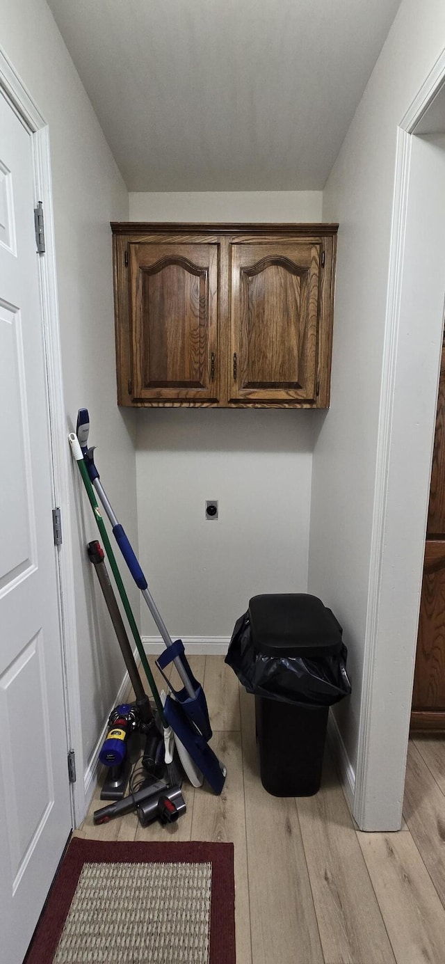 2782 W Swan St, Springfield, MO 65807 - laundry area with cabinet space and light wood-style floors