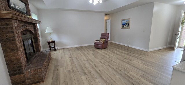 2782 W Swan St, Springfield, MO 65807 - unfurnished room featuring light wood finished floors and a fireplace