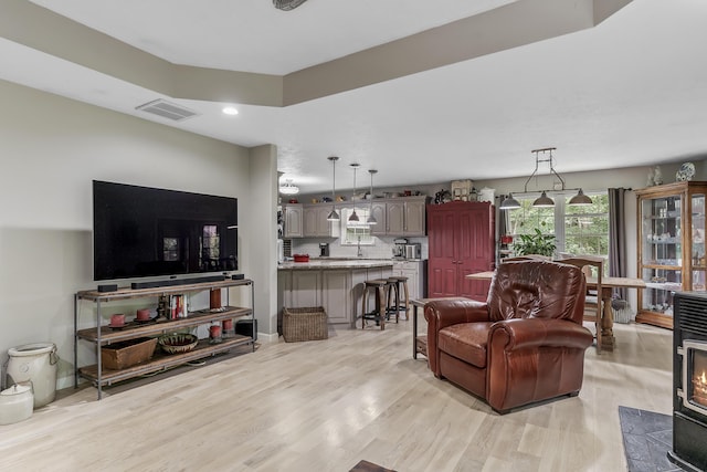 11996 N Farm Rd Unit 119, Brighton, MO 65617 - living room with light wood-style flooring, a wood stove, and recessed lighting