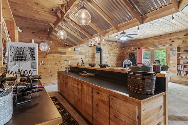 11996 N Farm Rd Unit 119, Brighton, MO 65617 - kitchen featuring wooden walls, dark countertops, lofted ceiling, ceiling fan, and a wood stove