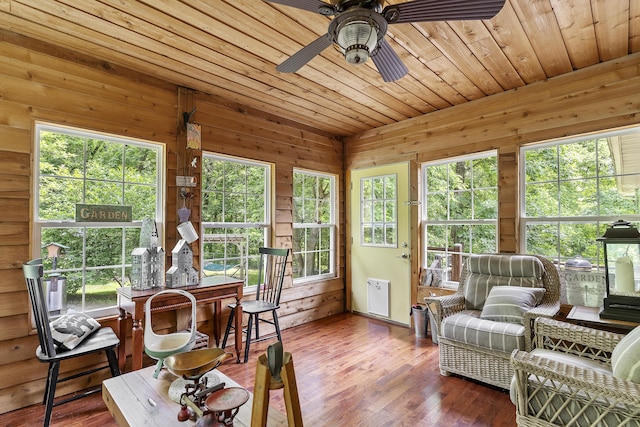 11996 N Farm Rd Unit 119, Brighton, MO 65617 - sunroom / solarium with wood walls, wood ceiling, wood finished floors, a deck, and radiator heating unit