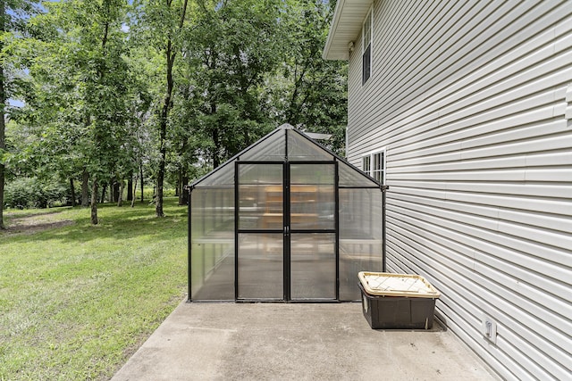 11996 N Farm Rd Unit 119, Brighton, MO 65617 - view of patio / terrace featuring a greenhouse and an outbuilding