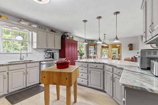 11996 N Farm Rd Unit 119, Brighton, MO 65617 - kitchen featuring gray cabinetry, a peninsula, healthy amount of natural light, and decorative backsplash