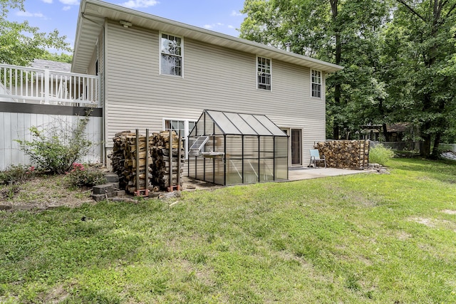 11996 N Farm Rd Unit 119, Brighton, MO 65617 - back of property featuring a greenhouse, a lawn, an outdoor structure, a patio, and a deck