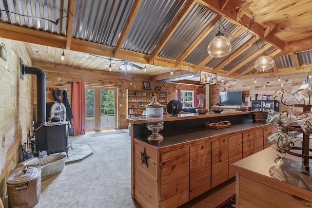 11996 N Farm Rd Unit 119, Brighton, MO 65617 - office area featuring a wood stove, wooden walls, carpet, and ceiling fan