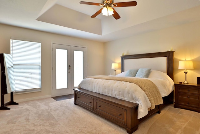185 Tanner Rd, Branson, MO 65616 - bedroom with access to outside, a tray ceiling, french doors, light colored carpet, and a ceiling fan