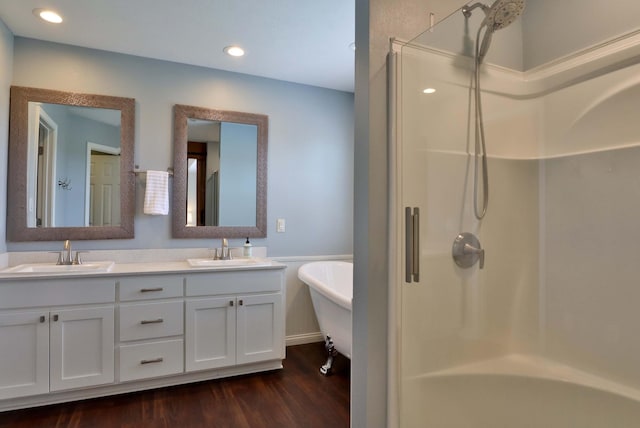 185 Tanner Rd, Branson, MO 65616 - bathroom with a freestanding bath, wood finished floors, double vanity, a shower, and recessed lighting