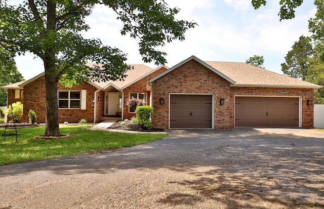 185 Tanner Rd, Branson, MO 65616 - single story home with an attached garage, driveway, and brick siding
