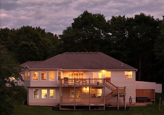 185 Tanner Rd, Branson, MO 65616 - rear view of house featuring a covered hot tub, a wooden deck, stairs, and a lawn