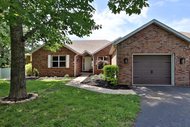 185 Tanner Rd, Branson, MO 65616 - ranch-style house with a garage, a front yard, brick siding, driveway, and roof with shingles