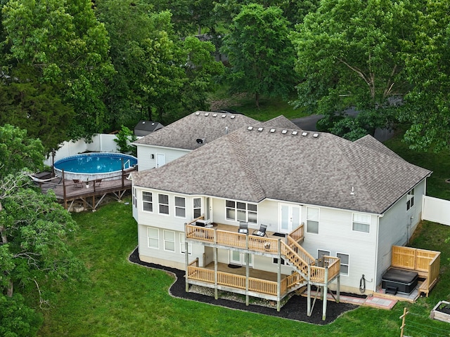 185 Tanner Rd, Branson, MO 65616 - rear view of house with a jacuzzi, a wooden deck, roof with shingles, and a fenced backyard