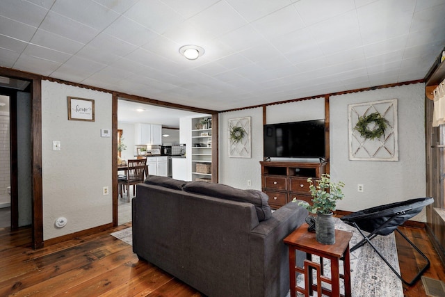 901 S 5th St, Ozark, MO 65721 - living area with dark wood-style floors and a textured wall