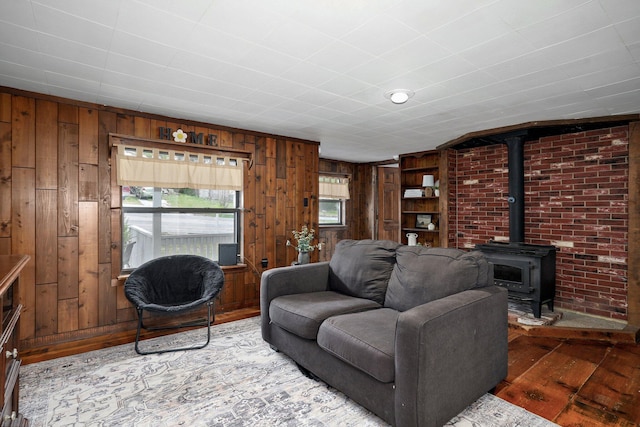 901 S 5th St, Ozark, MO 65721 - living room featuring wood walls, hardwood / wood-style floors, and a wood stove