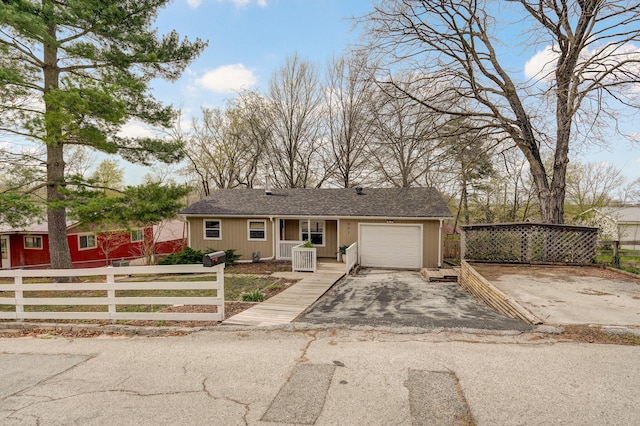 901 S 5th St, Ozark, MO 65721 - ranch-style home featuring a fenced front yard, a garage, asphalt driveway, and roof with shingles
