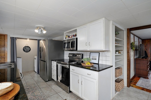 901 S 5th St, Ozark, MO 65721 - kitchen featuring stainless steel appliances, open shelves, washer and clothes dryer, white cabinets, and built in shelves