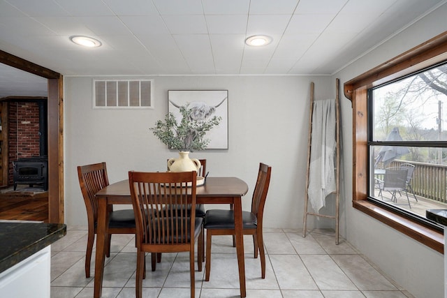 901 S 5th St, Ozark, MO 65721 - dining space featuring a wood stove and light tile patterned flooring