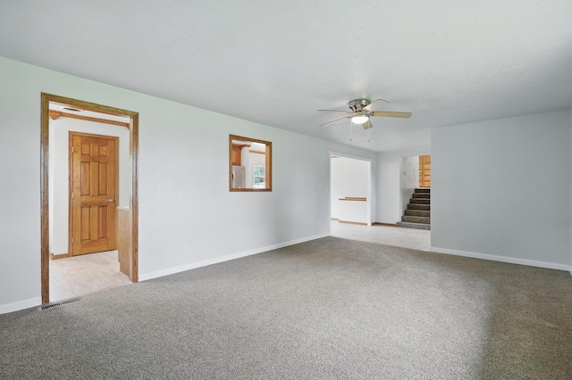14289 Bethel Rd, Seneca, MO 64865 - unfurnished living room featuring ceiling fan, stairs, and carpet floors