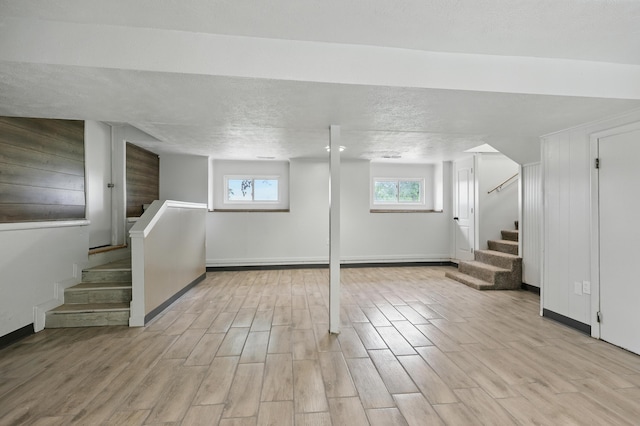 14289 Bethel Rd, Seneca, MO 64865 - basement featuring stairs, light wood finished floors, and a textured ceiling