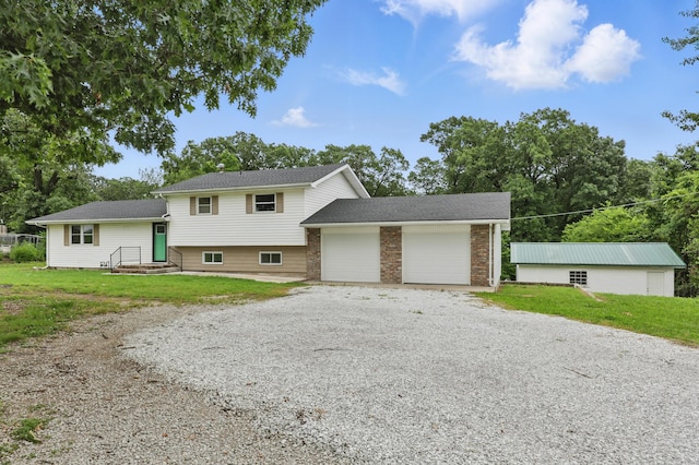 14289 Bethel Rd, Seneca, MO 64865 - split level home with driveway, a garage, and a front lawn