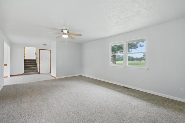 14289 Bethel Rd, Seneca, MO 64865 - unfurnished room with a ceiling fan, light carpet, and stairs