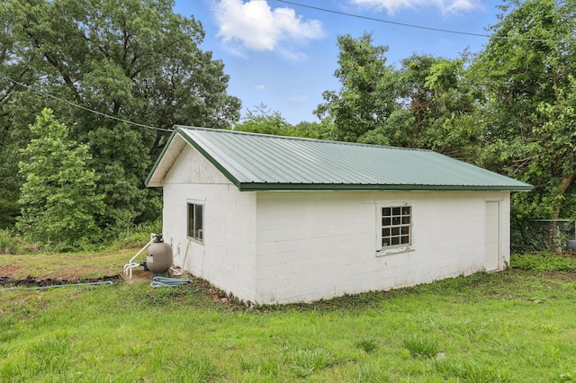 14289 Bethel Rd, Seneca, MO 64865 - view of side of property featuring concrete block siding, a yard, and a metal roof