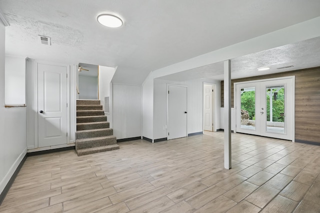 14289 Bethel Rd, Seneca, MO 64865 - below grade area with light wood-style flooring, stairs, a textured ceiling, french doors, and ceiling fan