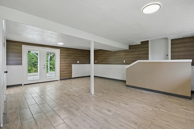 14289 Bethel Rd, Seneca, MO 64865 - unfurnished living room featuring wooden walls, wood finished floors, and french doors