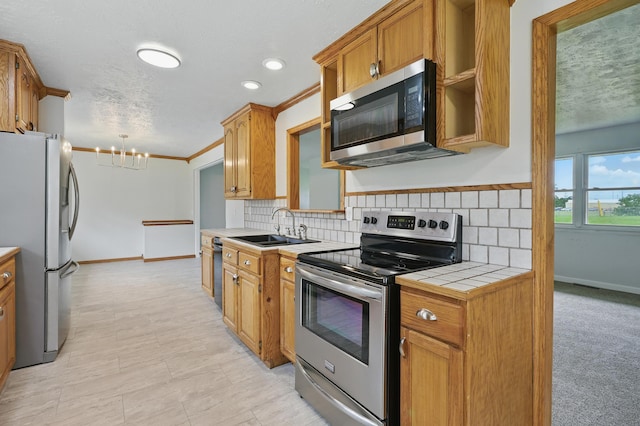 14289 Bethel Rd, Seneca, MO 64865 - kitchen featuring stainless steel appliances, tile countertops, backsplash, a chandelier, and recessed lighting