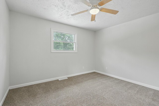 14289 Bethel Rd, Seneca, MO 64865 - carpeted empty room with a textured ceiling and ceiling fan