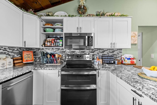 720 E Burford St, Marshfield, MO 65706 - kitchen with stainless steel appliances, vaulted ceiling, tasteful backsplash, white cabinetry, and light stone countertops
