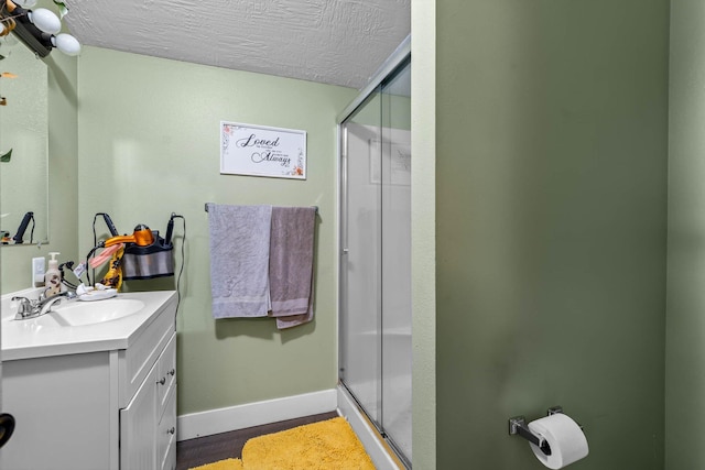 720 E Burford St, Marshfield, MO 65706 - bathroom with vanity, a shower stall, and a textured ceiling