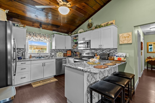 720 E Burford St, Marshfield, MO 65706 - kitchen featuring appliances with stainless steel finishes, a peninsula, wooden ceiling, open shelves, and dark wood-style floors