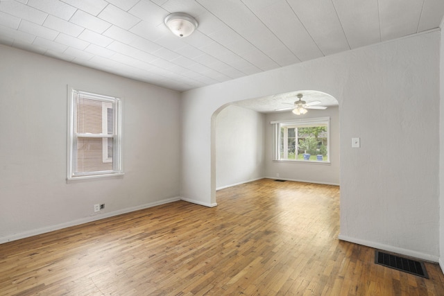 825 W Nichols St, Springfield, MO 65802 - spare room with arched walkways, hardwood / wood-style floors, and ceiling fan