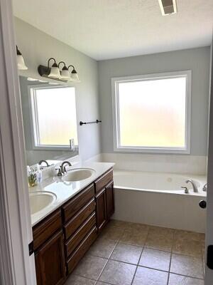 201 Sparrow Ln, Willard, MO 65781 - full bath with a garden tub, double vanity, and tile patterned flooring