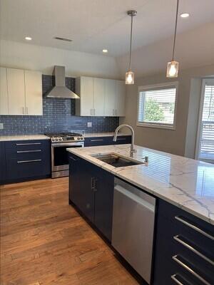 201 Sparrow Ln, Willard, MO 65781 - kitchen with wall chimney range hood, appliances with stainless steel finishes, white cabinets, decorative backsplash, and recessed lighting
